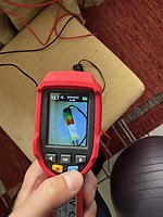 Measuring the temperature of the mobile USB-C charger after approximately 10 minutes of use with full load.